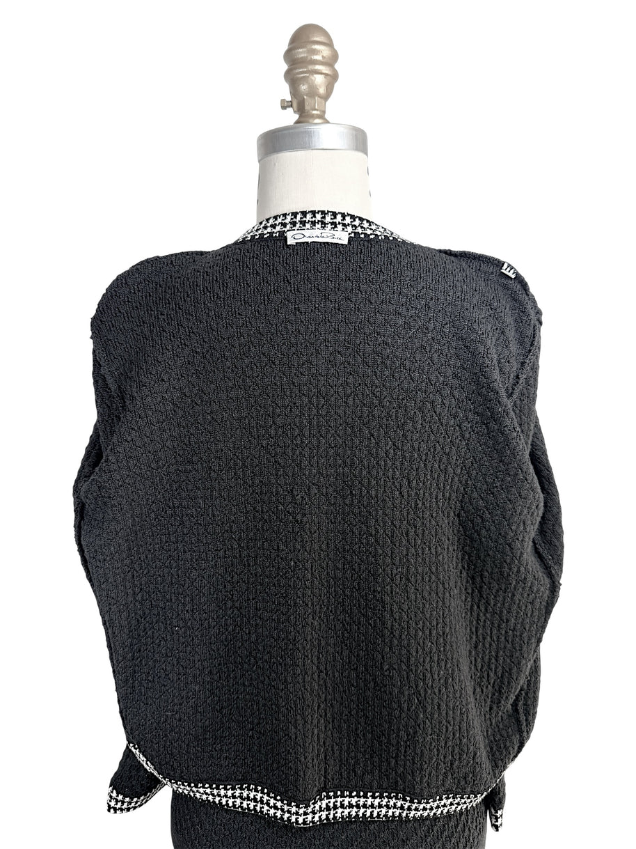 Full back view of Oscar de la Renta textured black wool cardigan on mannequin