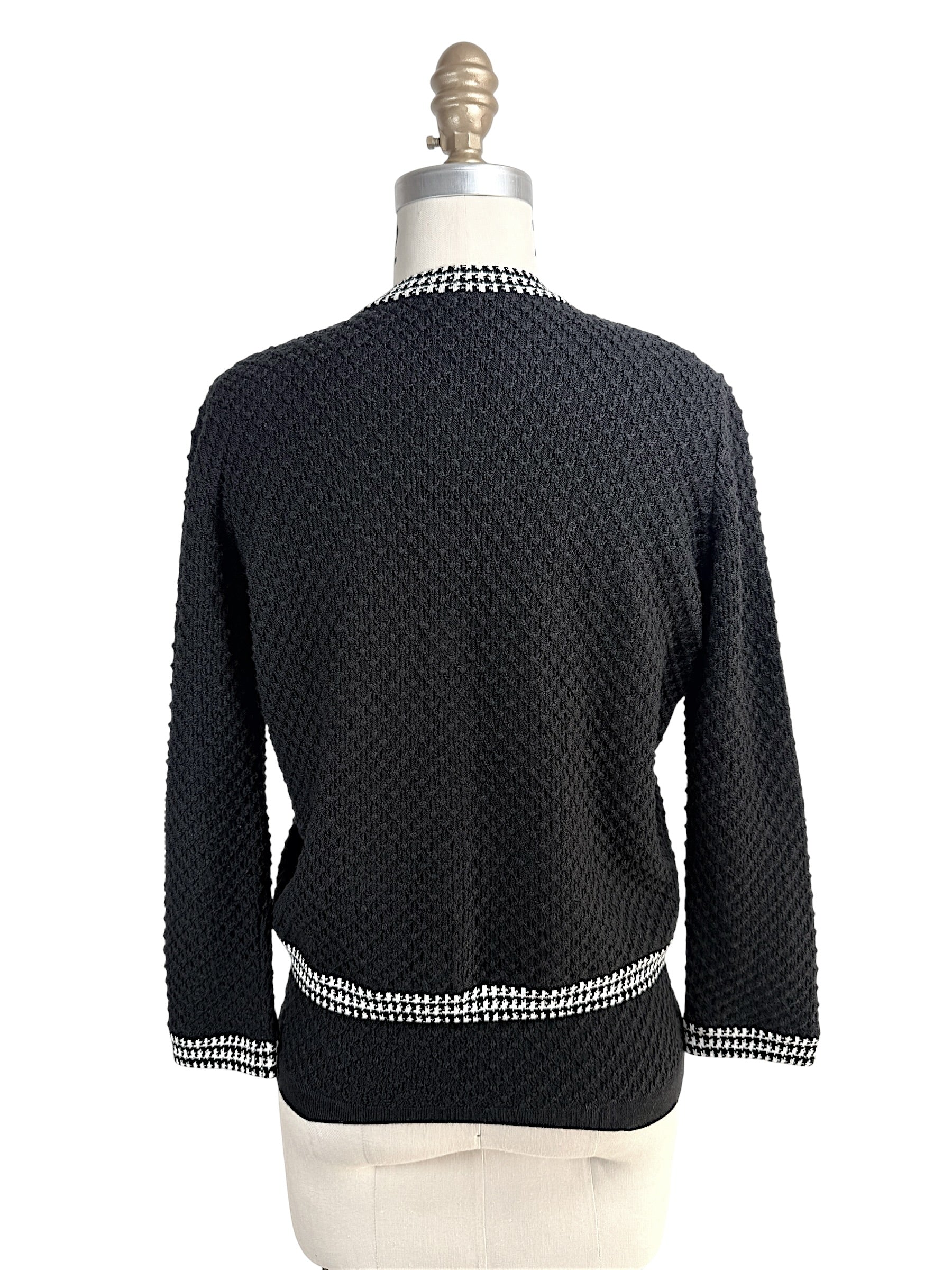 Back view of Oscar de la Renta black textured wool cardigan with houndstooth trim hem and collar