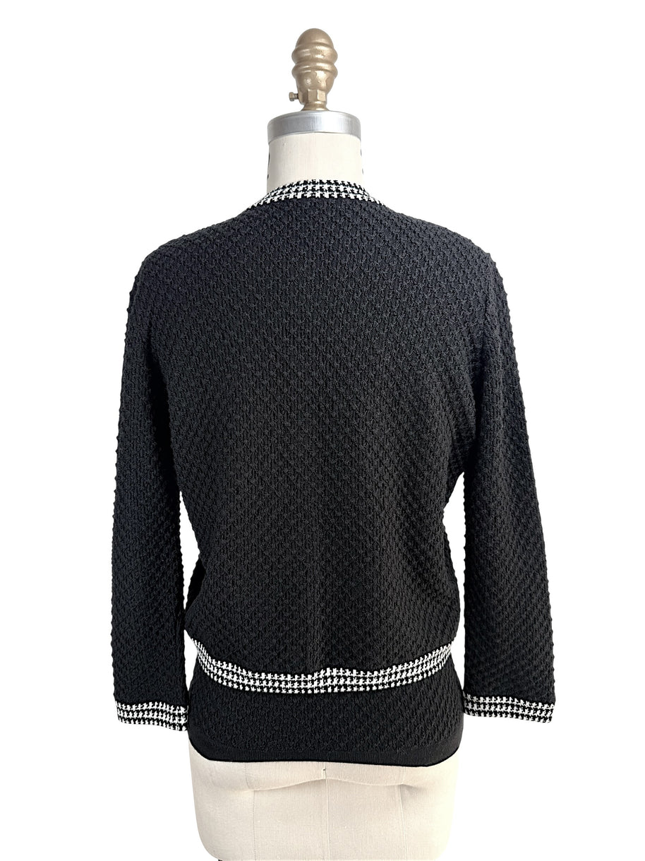Back view of Oscar de la Renta black textured wool cardigan with houndstooth trim hem and collar