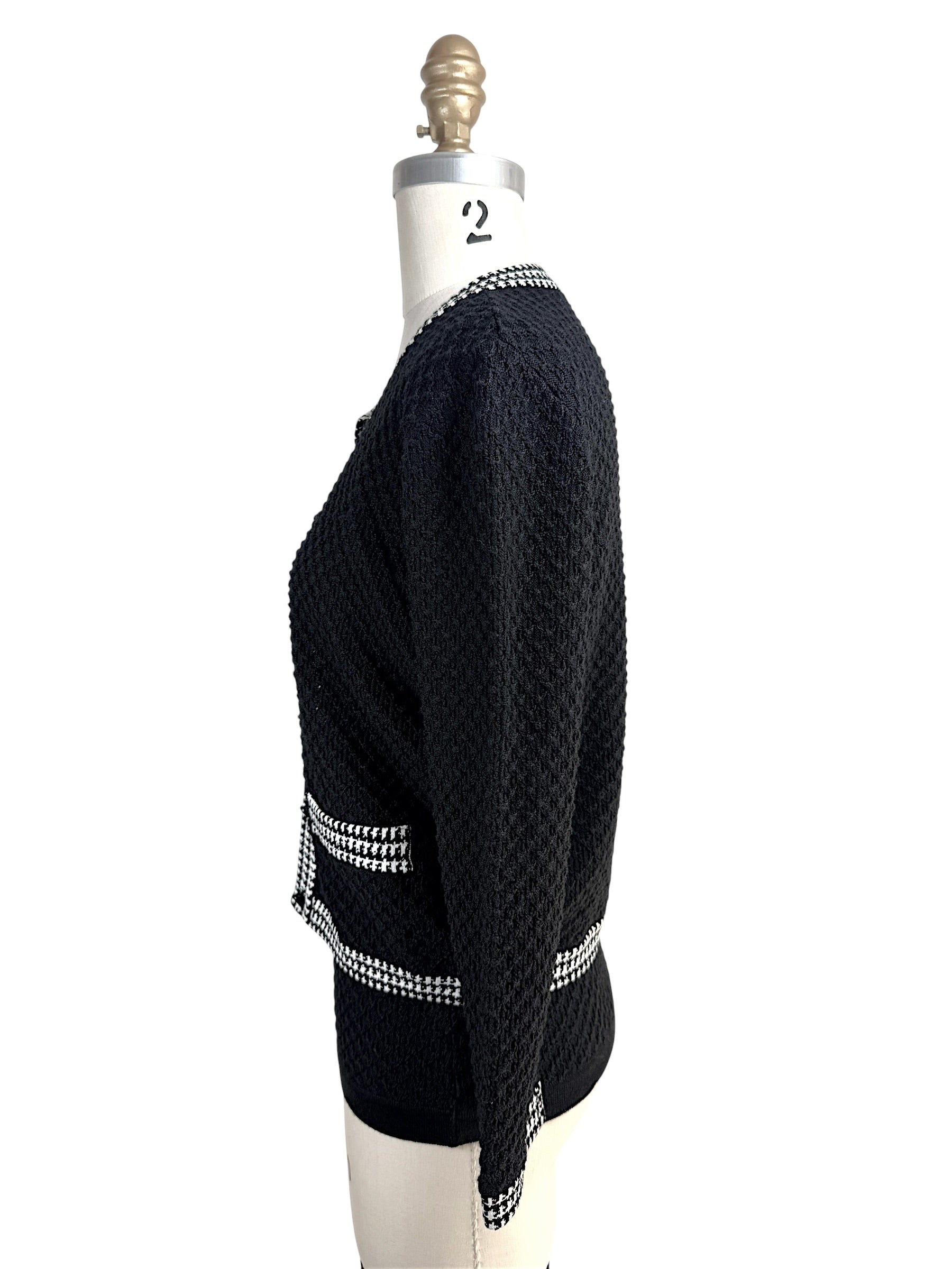 Left side profile of Oscar de la Renta black textured knit cardigan with contrast trim pockets