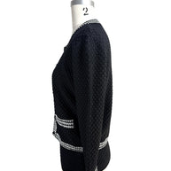 Left side profile of Oscar de la Renta black textured knit cardigan with contrast trim pockets