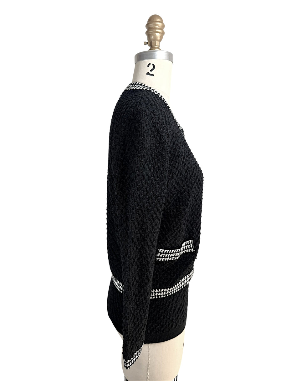 Right side profile of Oscar de la Renta textured black wool cardigan on mannequin