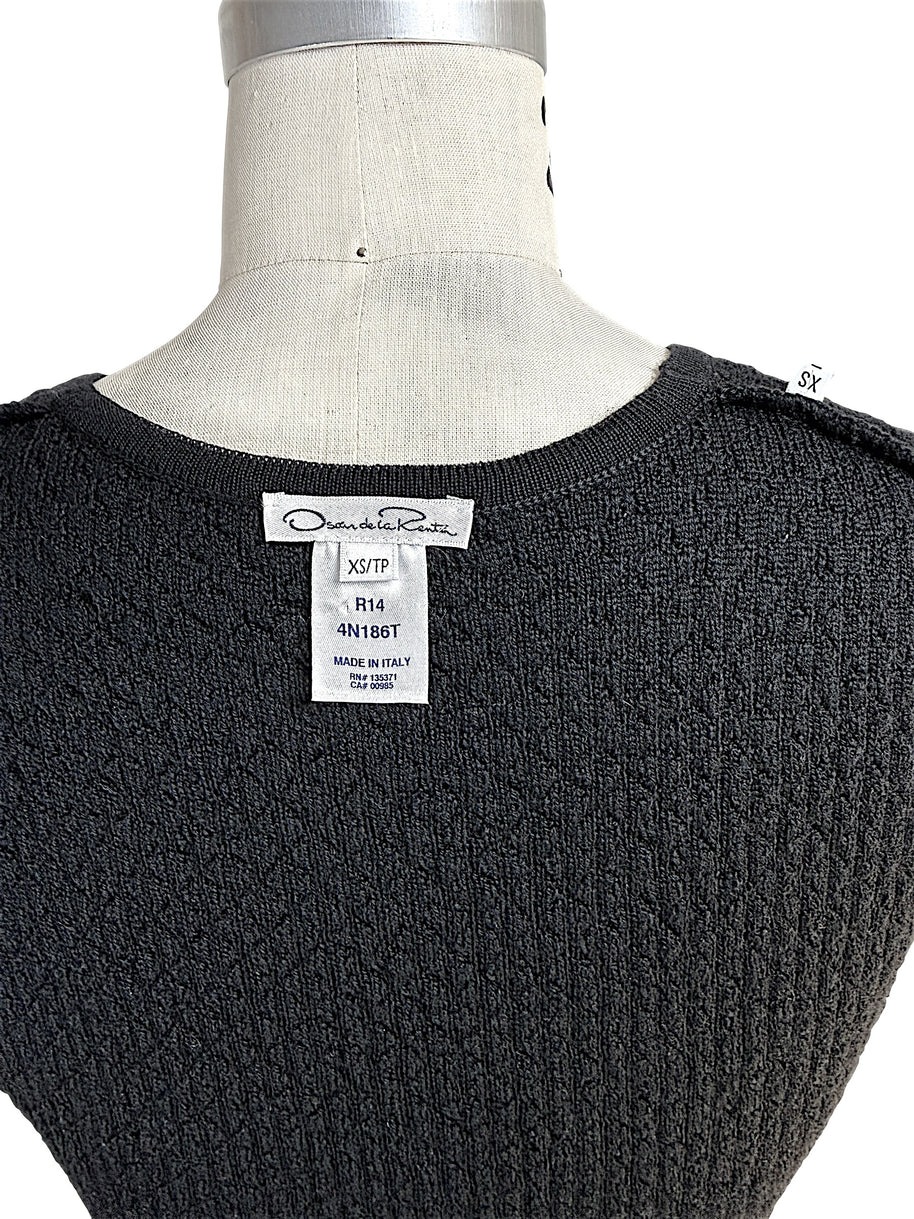 Back detail of Oscar de la Renta black textured knit shell showing designer label and textured knit fabric