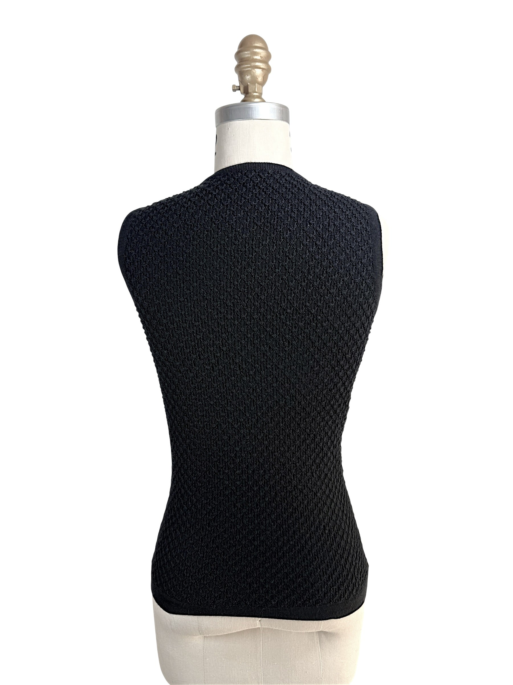 Back view of Oscar de la Renta textured black wool knit shell top on mannequin