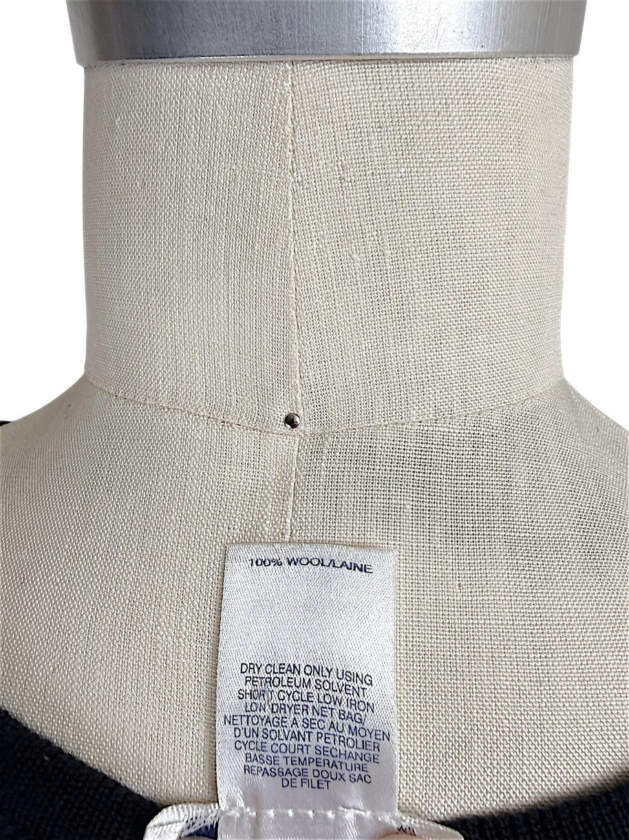 Oscar de la Renta knit shell interior care tag showing 100 percent wool composition and cleaning instructions