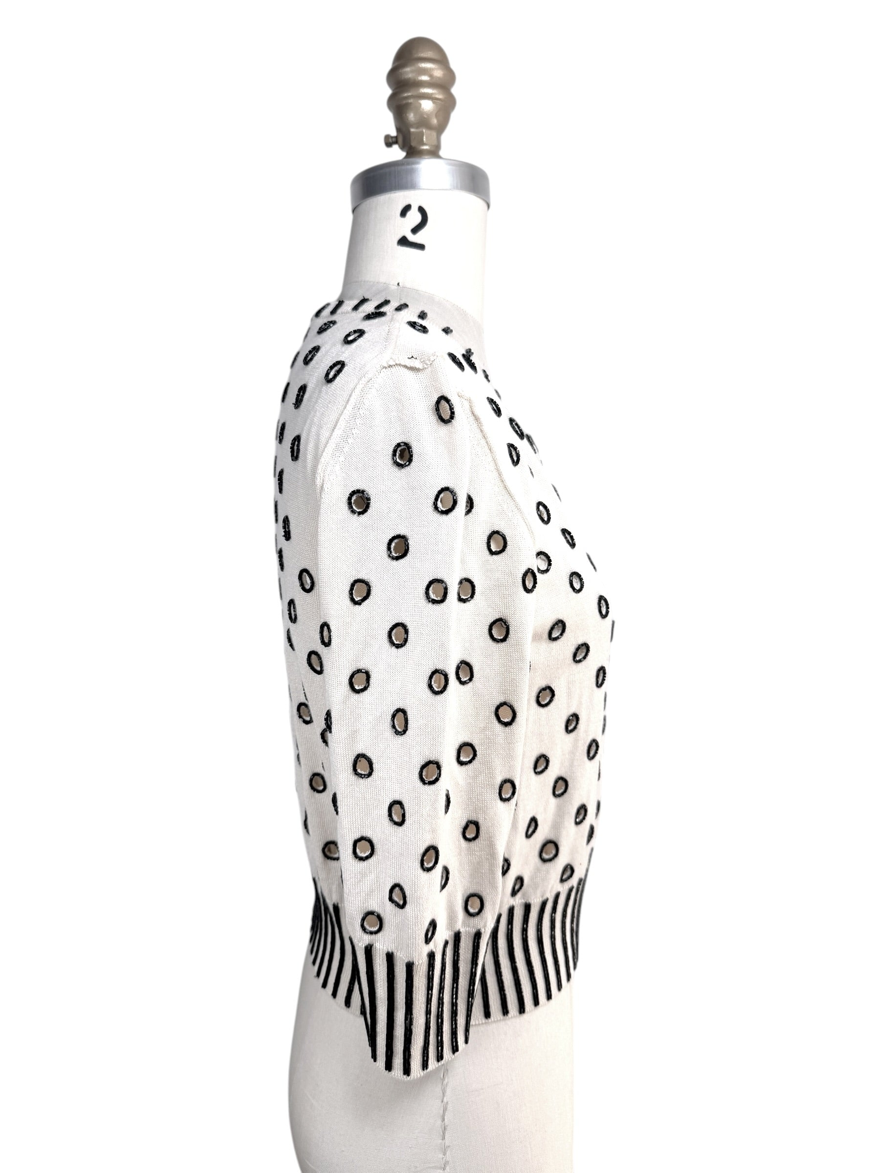 Right side profile of Oscar de la Renta ivory cardigan sweater with black beaded embroidery details