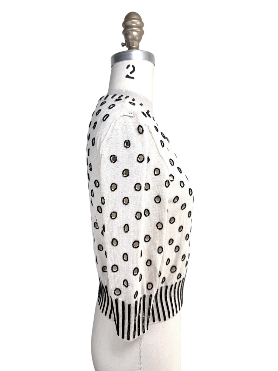 Right side profile of Oscar de la Renta ivory cardigan sweater with black beaded embroidery details