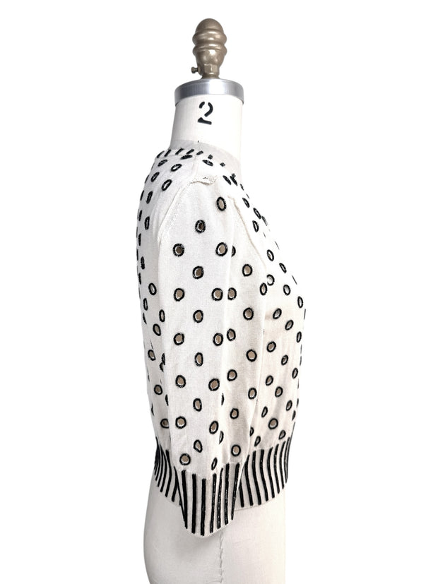 Right side profile of Oscar de la Renta ivory cardigan sweater with black beaded embroidery details