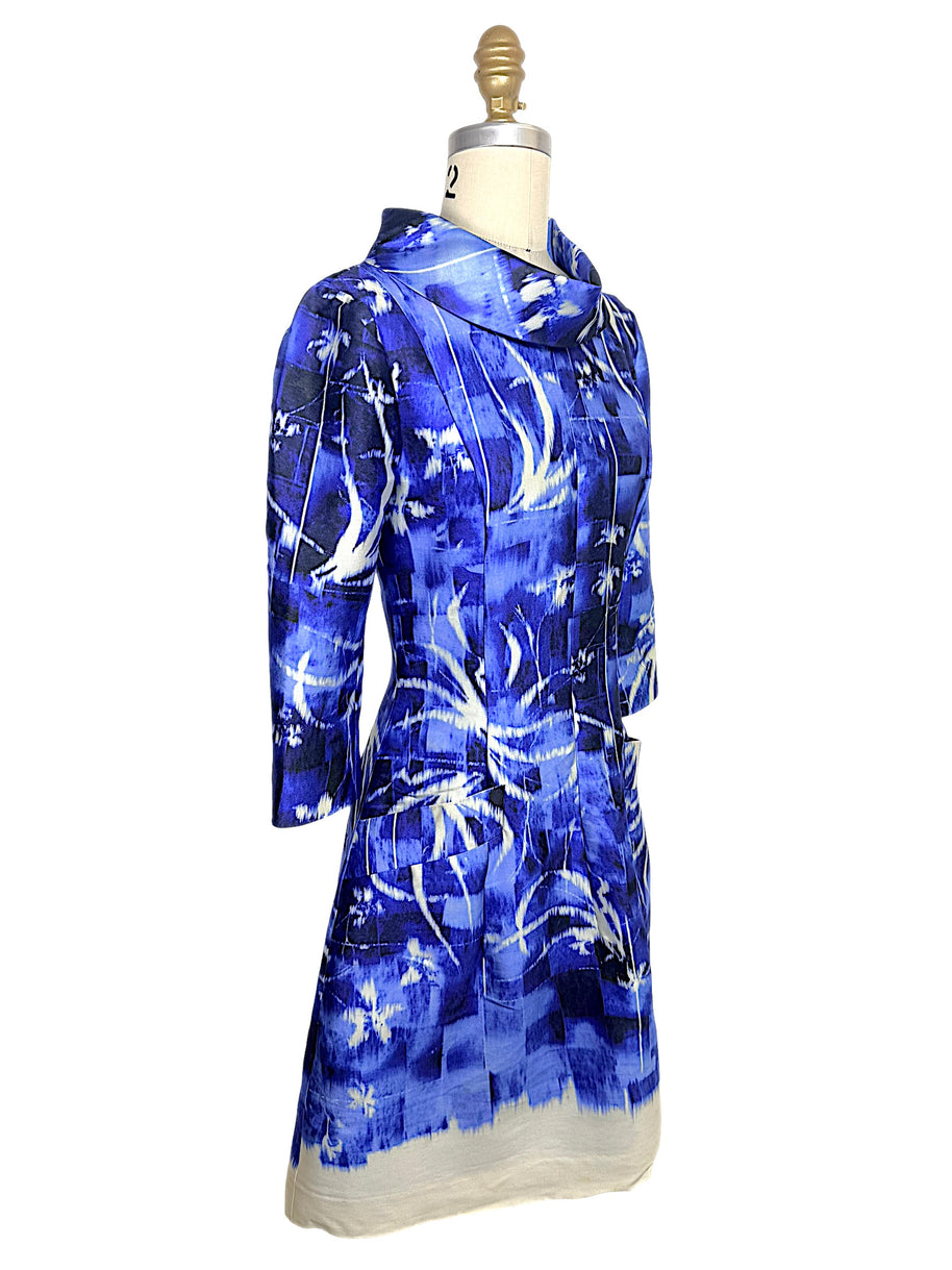 Three-quarter front view of the Oscar de la Renta Pre-Fall 2014 abstract blue dress highlighting the tailored silhouette, sculptural collar, and front patch pocket.