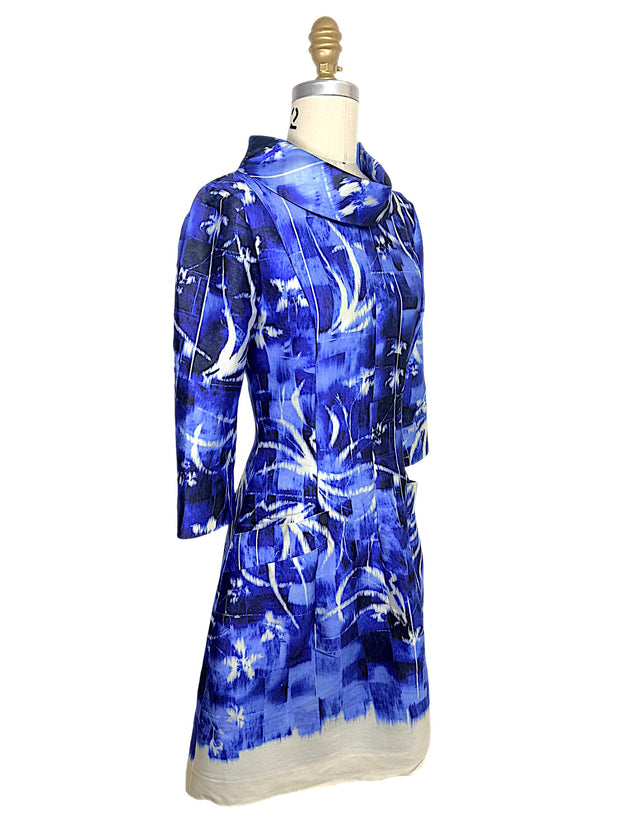 Three-quarter front view of the Oscar de la Renta Pre-Fall 2014 abstract blue dress highlighting the tailored silhouette, sculptural collar, and front patch pocket.