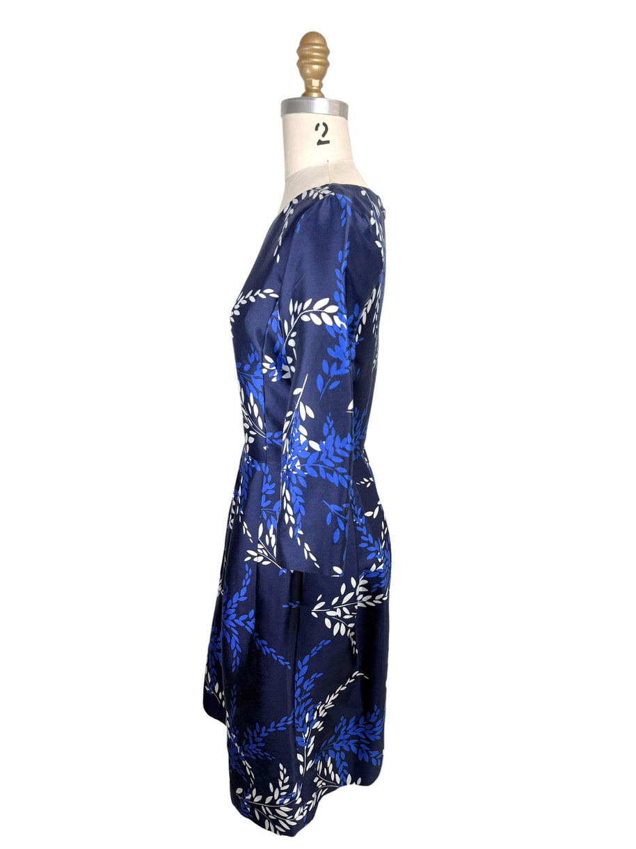 Right side profile of Oscar de la Renta navy silk blend cocktail dress with pleated skirt and three-quarter sleeves