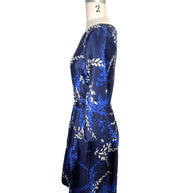 Right side profile of Oscar de la Renta navy silk blend cocktail dress with pleated skirt and three-quarter sleeves
