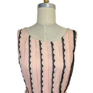 Close-up of the Oscar de la Renta Resort 2014 blush pink dress highlighting the rounded neckline, tailored bodice, and vertical black lace stripe detailing.