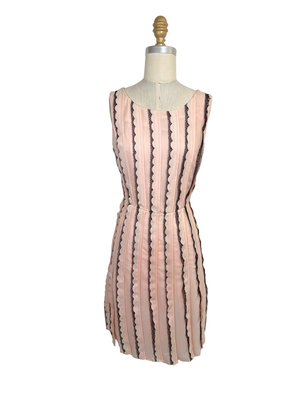 Oscar de la Renta Resort 2014 blush pink sleeveless dress featuring black lace stripe detailing and a fit-and-flare silhouette shown from the front.