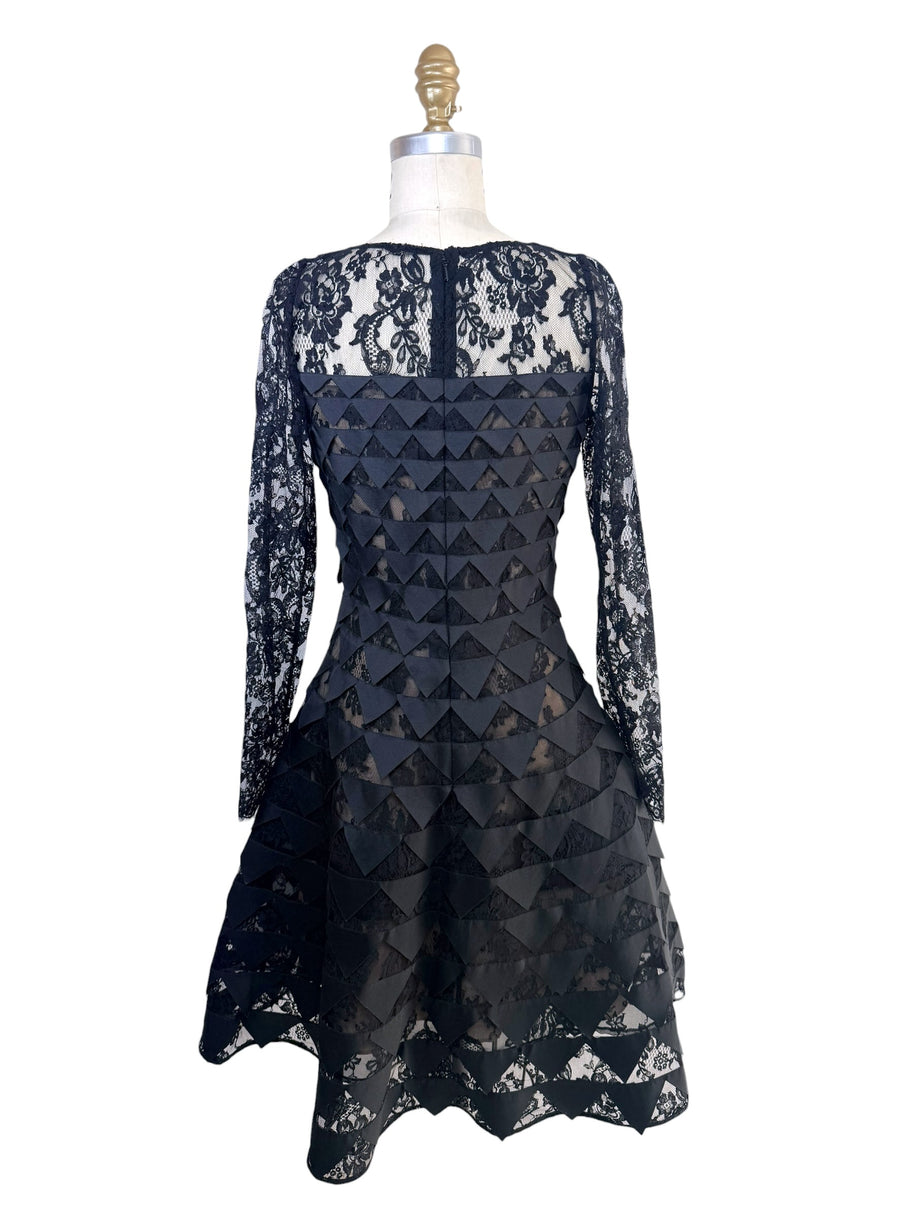 Back full view of Oscar de la Renta Resort 2018 black lace cocktail dress with illusion back and asymmetric hem
