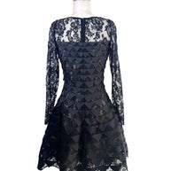 Back full view of Oscar de la Renta Resort 2018 black lace cocktail dress with illusion back and asymmetric hem
