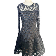Oscar de la Renta Resort 2018 black lace cocktail dress with geometric appliqué detailing and asymmetric hem front full view