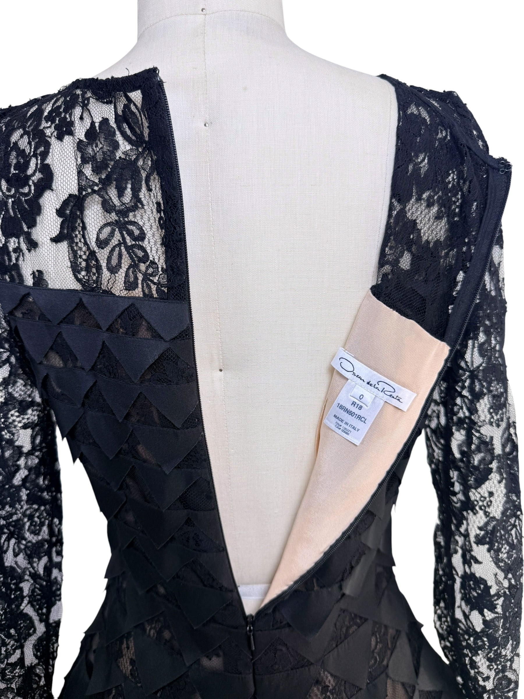 Interior label overview of Oscar de la Renta Resort 2018 black lace dress showing back zipper and designer tags
