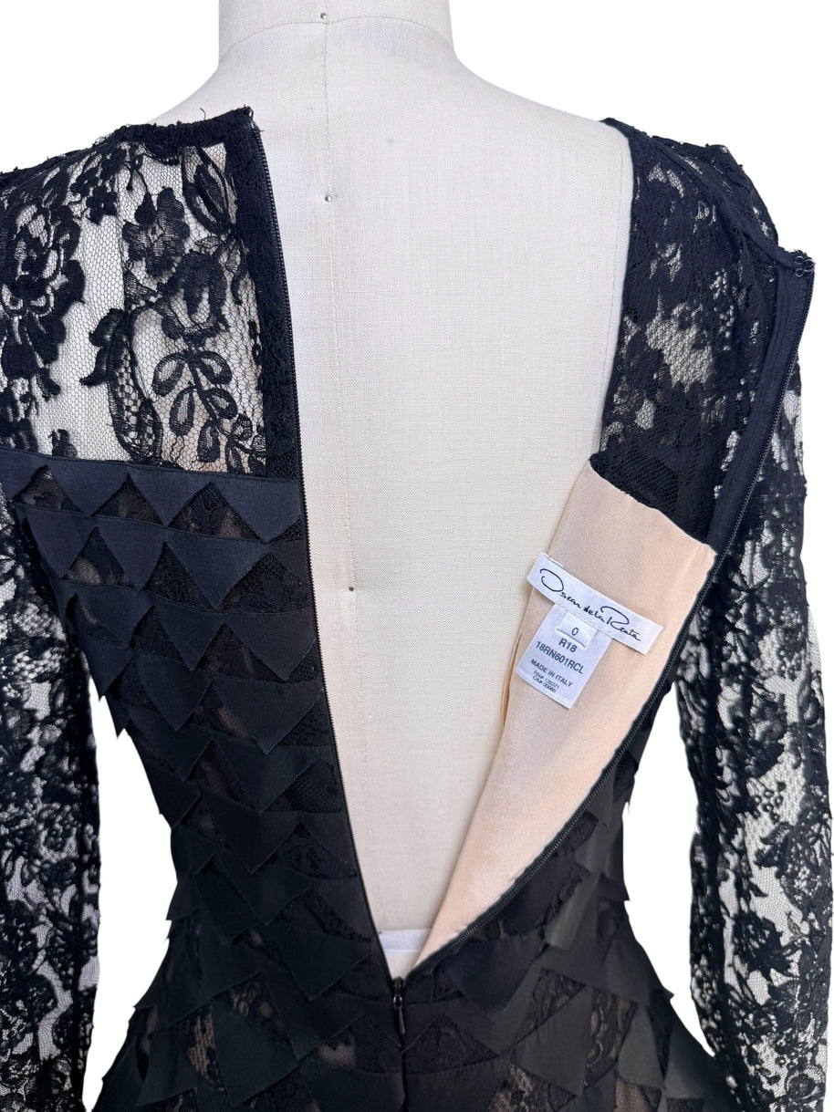 Interior label overview of Oscar de la Renta Resort 2018 black lace dress showing back zipper and designer tags