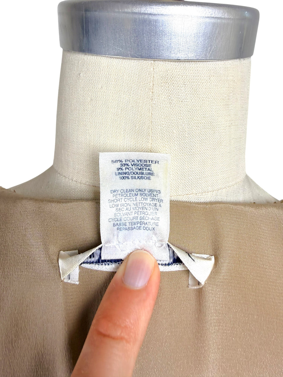 Close-up of Oscar de la Renta Resort 2018 dress fabric composition and care instruction tag showing silk lining and metallic blend composition