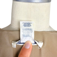 Close-up of Oscar de la Renta Resort 2018 dress fabric composition and care instruction tag showing silk lining and metallic blend composition