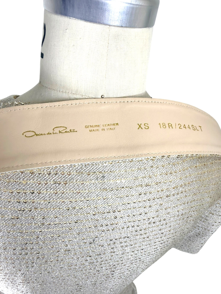 Detail view of Oscar de la Renta metallic gold dress belt with genuine leather backing and embossed branding