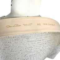 Detail view of Oscar de la Renta metallic gold dress belt with genuine leather backing and embossed branding