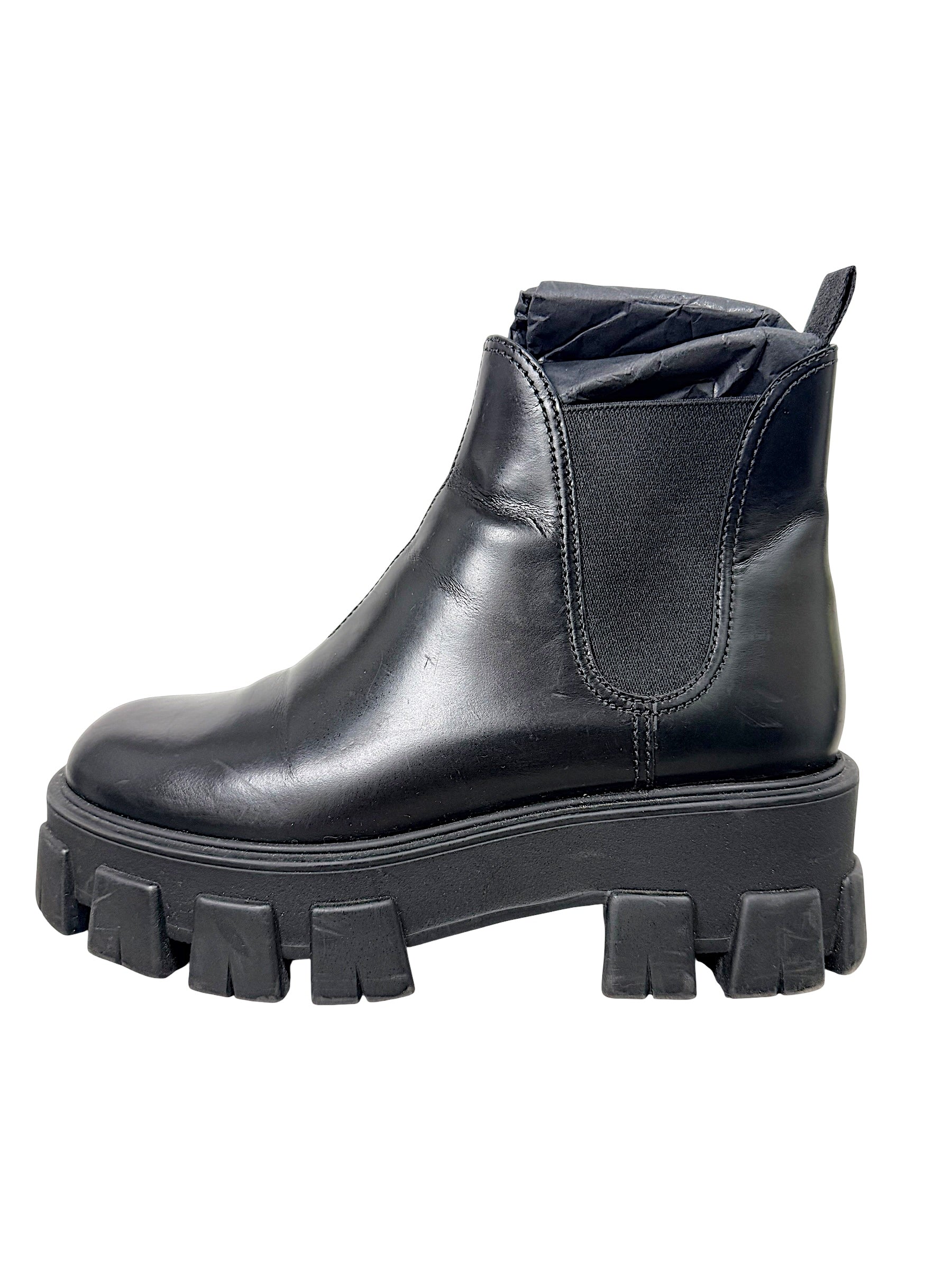 Prada Monolith black leather Chelsea boot showing natural creasing, scuffing and wear to leather upper