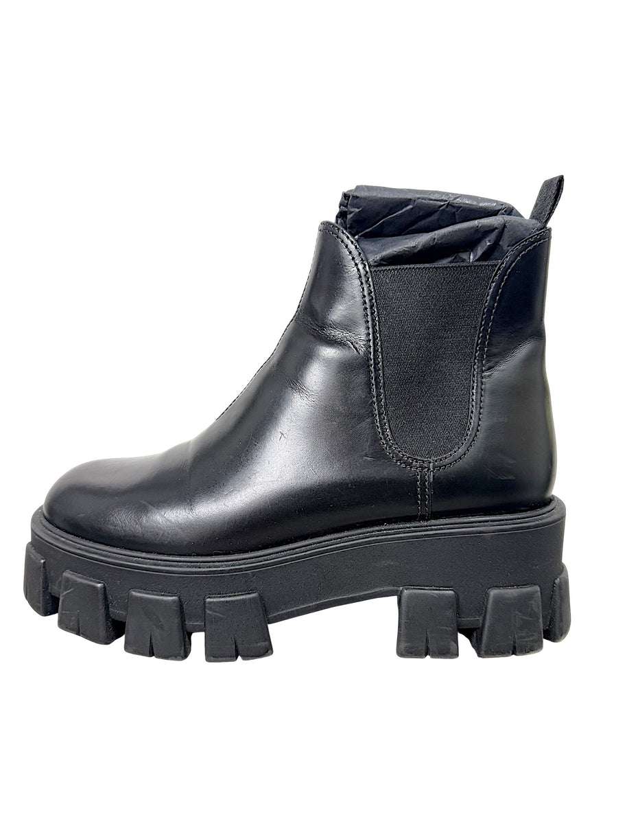 Prada Monolith black leather Chelsea boot showing natural creasing, scuffing and wear to leather upper