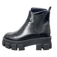 Prada Monolith black leather Chelsea boot showing natural creasing, scuffing and wear to leather upper
