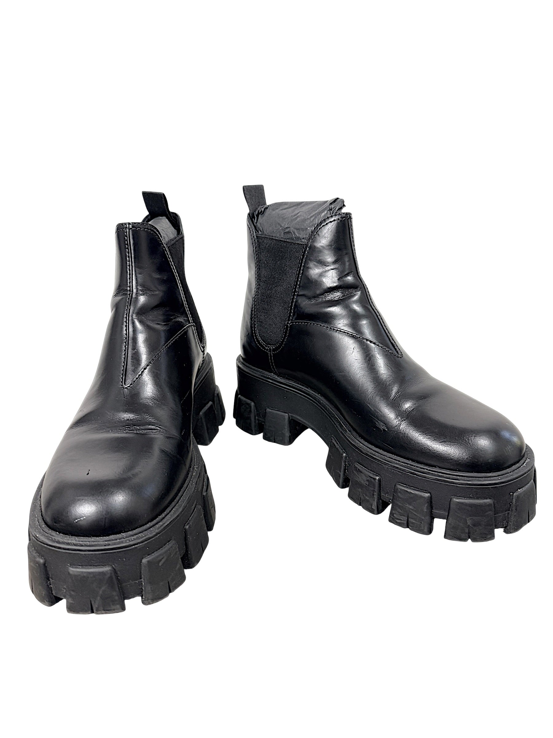 Prada Monolith black leather Chelsea ankle boots size 38 with chunky lug soles, front angled view