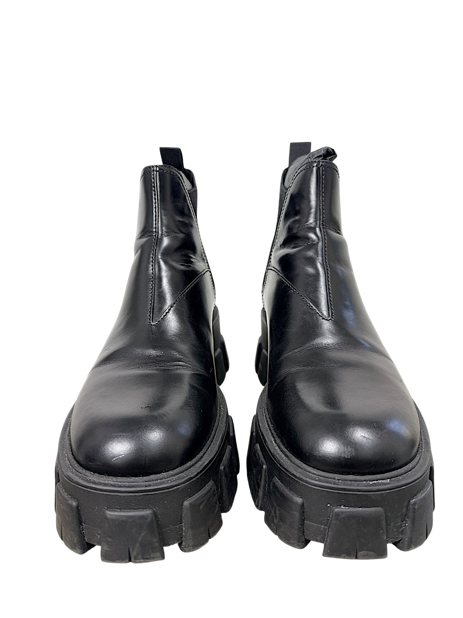 Front view of Prada Monolith black leather Chelsea boots size 38 with oversized lug soles