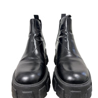 Front view of Prada Monolith black leather Chelsea boots size 38 with oversized lug soles