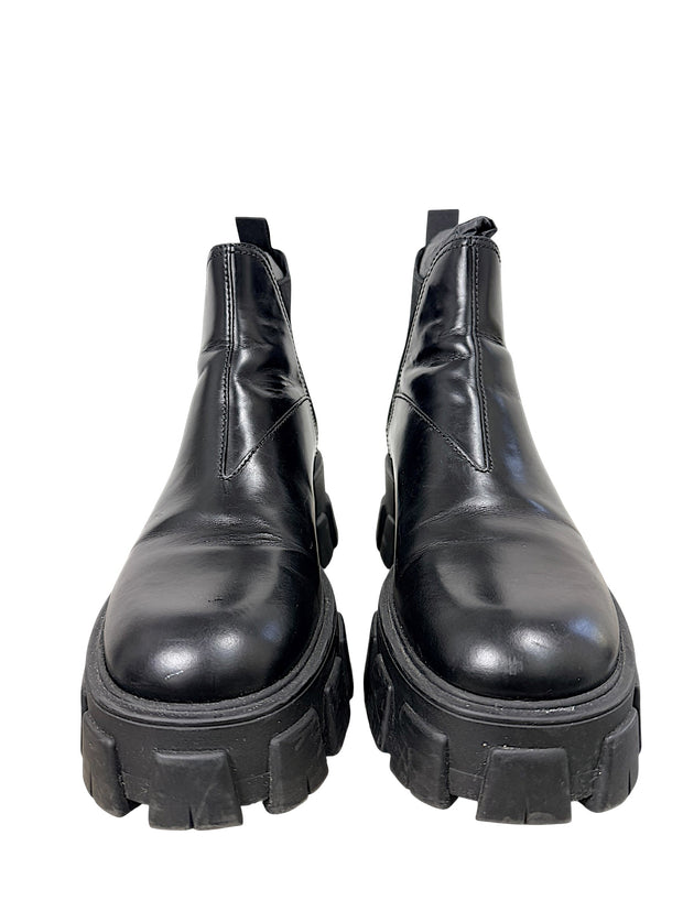 Front view of Prada Monolith black leather Chelsea boots size 38 with oversized lug soles