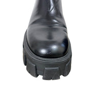 Close-up of Prada Monolith black leather Chelsea boot toe showing small scuff and condition of chunky lug sole