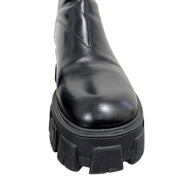 Close-up of Prada Monolith black leather Chelsea boot showing light toe scuffing, creasing and front lug sole