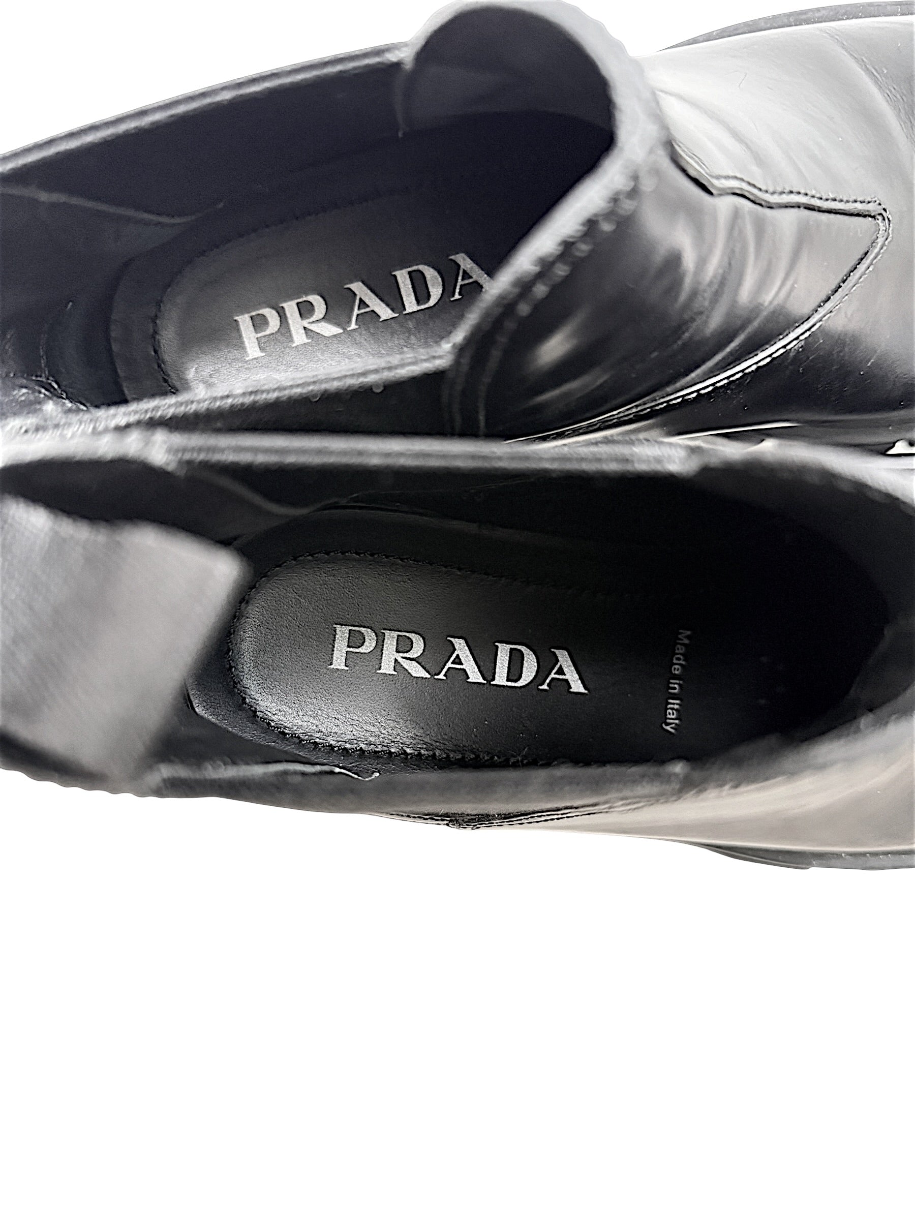 Interior of Prada Monolith black leather Chelsea boots showing Prada branded insoles and Made in Italy marking