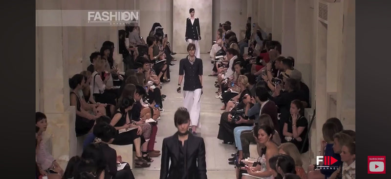 Runway video of Chanel Cruise 2014 Look 11 featuring the double-breasted textured tweed jacket in an alternate navy colorway, included as runway documentation for the ivory jacket listing.