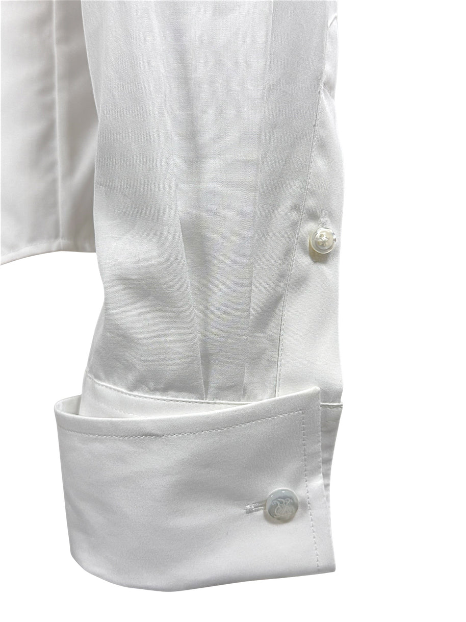 Close-up of Ralph Lauren Purple Label white cotton tuxedo shirt sleeve with elongated formal cuff and engraved button detailing.