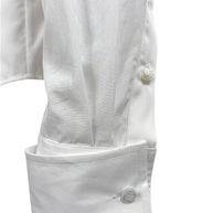 Close-up of Ralph Lauren Purple Label white cotton tuxedo shirt sleeve with elongated formal cuff and engraved button detailing.