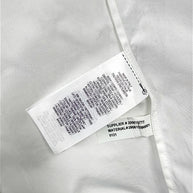Interior manufacturing and care labels of Ralph Lauren Purple Label white tuxedo shirt showing Made in Italy and material number 290615560001.