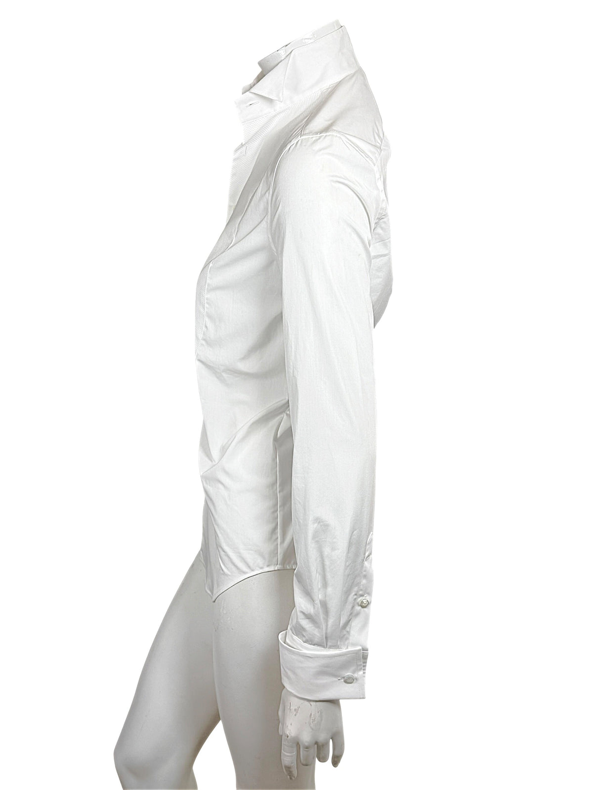 Opposite side view of Ralph Lauren Purple Label white tuxedo shirt displaying the long sleeve, fitted body and curved hem.