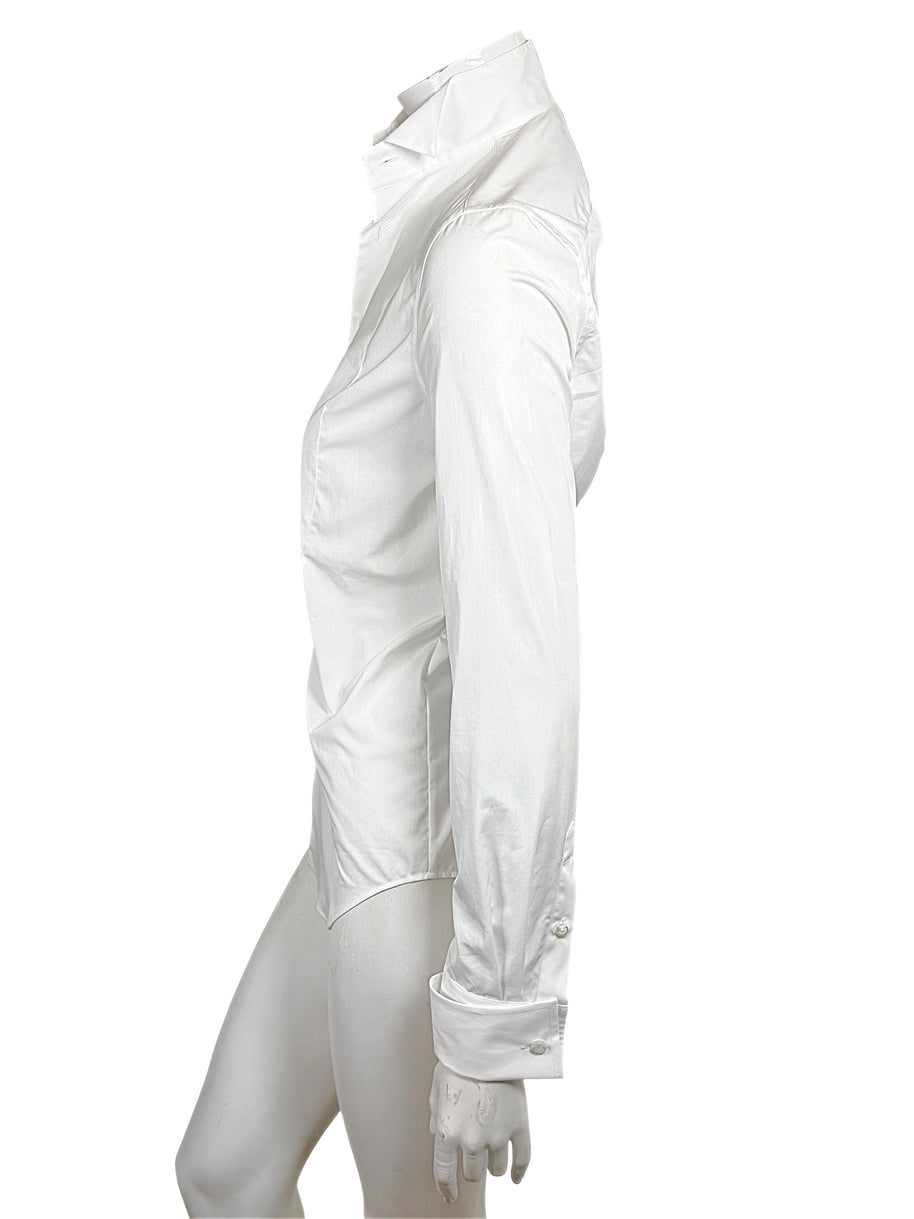 Opposite side view of Ralph Lauren Purple Label white tuxedo shirt displaying the long sleeve, fitted body and curved hem.