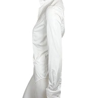 Opposite side view of Ralph Lauren Purple Label white tuxedo shirt displaying the long sleeve, fitted body and curved hem.