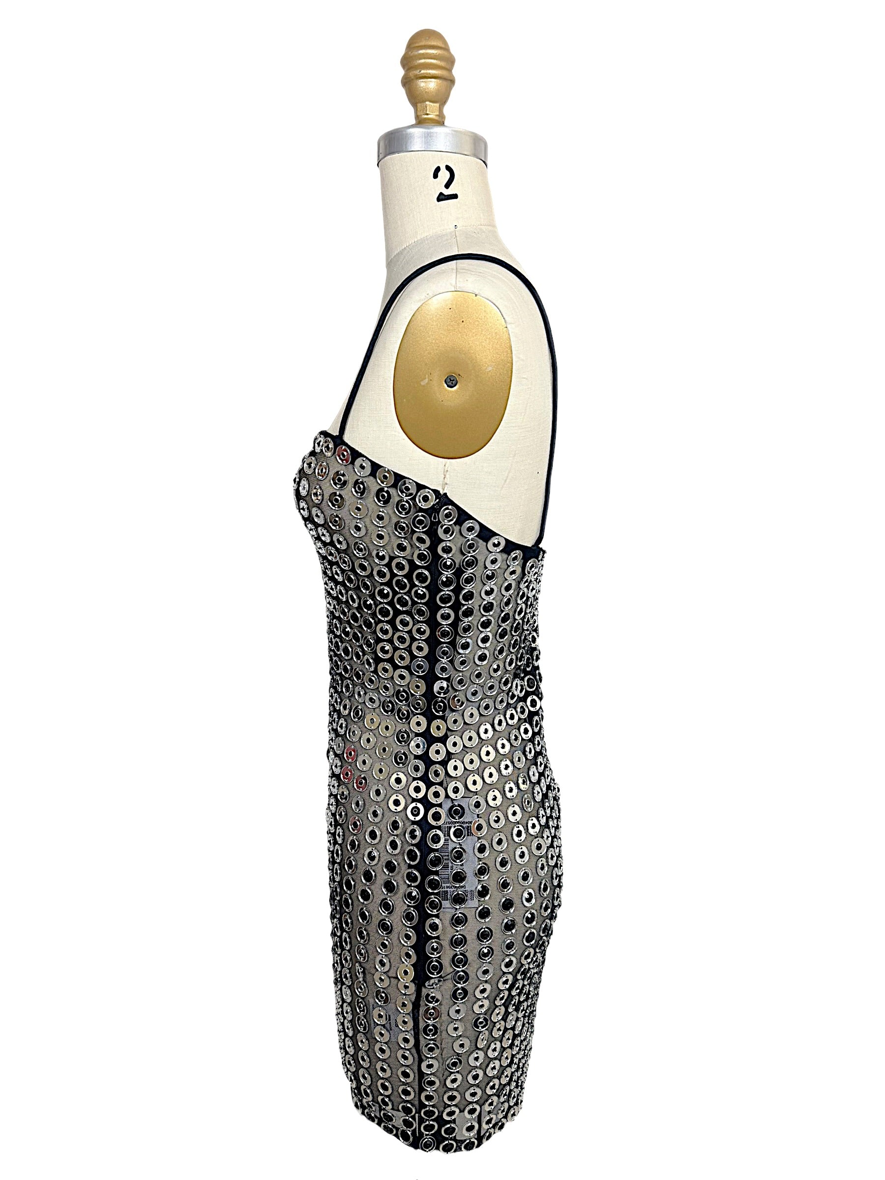 Opposite side view of Retrofête Maddy silver mirrored disc mini dress showing fitted bodycon silhouette