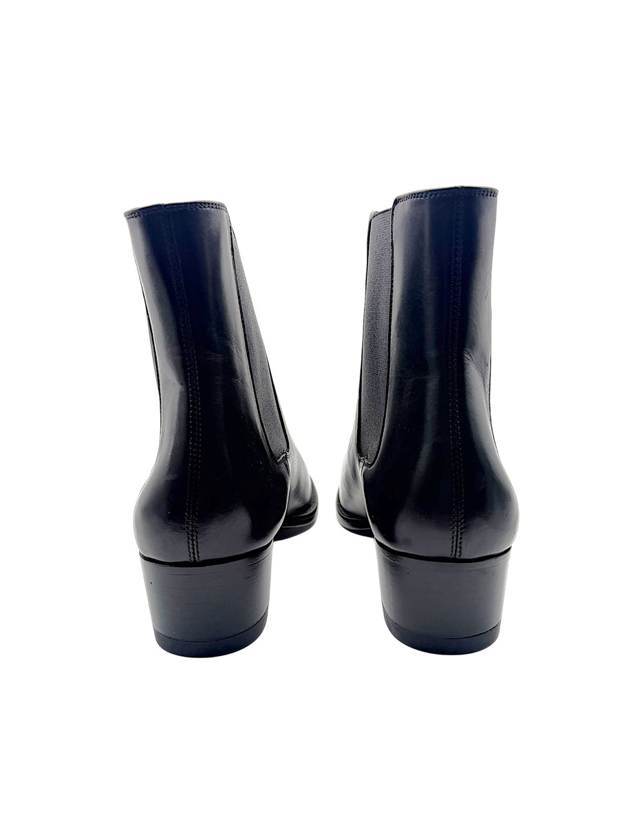 Rear view of Saint Laurent Paris black leather Chelsea ankle boots showing stitched back seams, low stacked heels and ankle shafts.