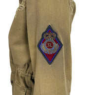 Close-up of Saint Laurent Paris olive green military jacket featuring multicolor embroidered SL crowned crest patch on upper sleeve.