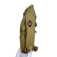 Side view of Saint Laurent olive green military jacket featuring colorful embroidered crowned SL crest patch on upper sleeve