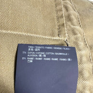 Saint Laurent Paris olive green military jacket composition label showing 77 percent cotton and 23 percent ramie fabric.