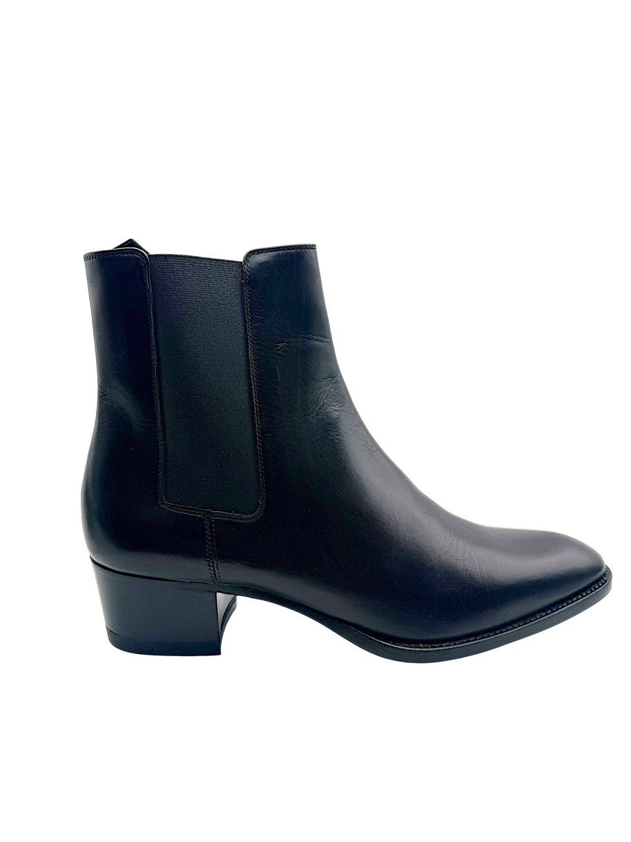 Side profile of Saint Laurent Paris black leather Chelsea ankle boot with stretch side panel, almond toe and low stacked block heel.
